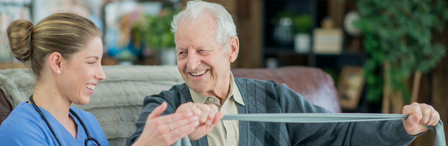 Elderly patient and nurse in physical therapy session.