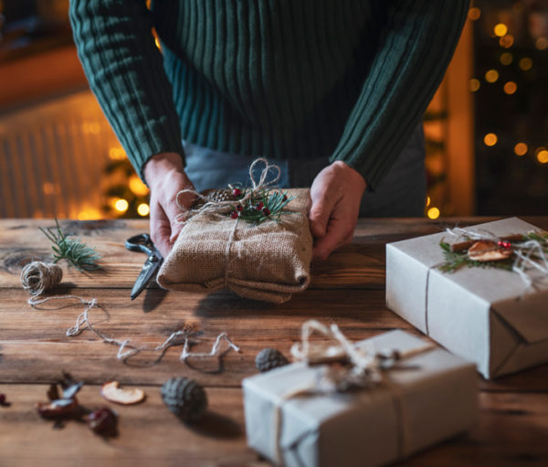 Hands wrapping Christmas gifts